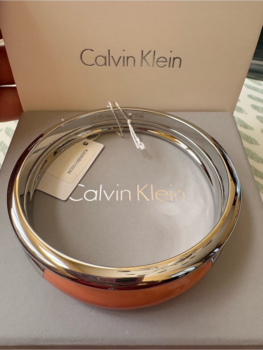 Calvin Klein Women’s Silver and Coral Bangle Bracelet